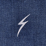 silver lightning bolt patch on blue denim fabric