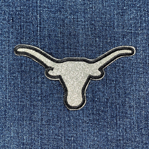 Embroidered longhorn patch on a denim background