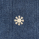 silver snowflake patch on a denim background