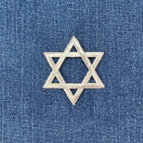 silver Star of David patch on blue denim fabric