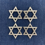 4 silver star of David patches on a denim background