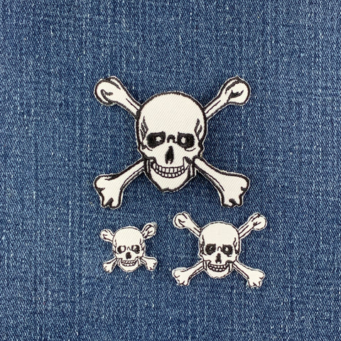 Skull and crossbones patches on a denim background