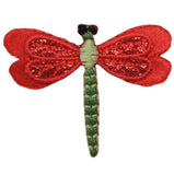 Red dragonfly-shaped patch on a white background