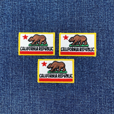 three small california flag patches on a denim background