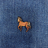 Embroidered horse patch on blue denim fabric