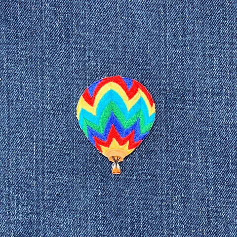 Colorful hot air balloon patch on denim fabric