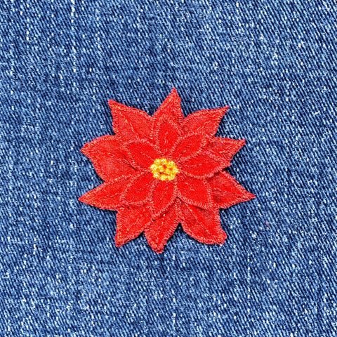 Red flower patch on blue denim fabric