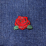 Red rose patch on blue denim fabric