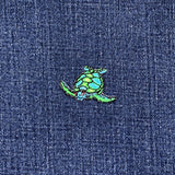 Green and blue sea turtle patch on a denim background