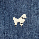 White poodle patch on blue denim fabric