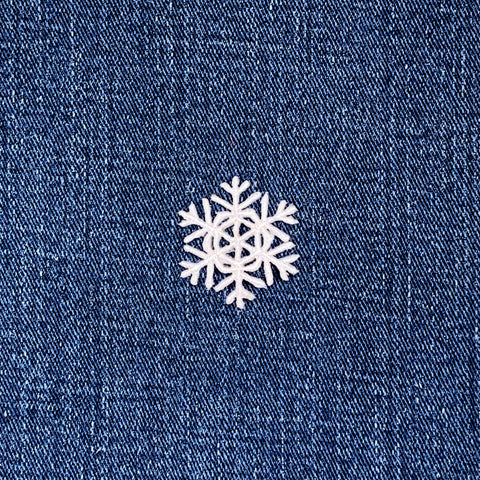 White snowflake patch on a blue denim background