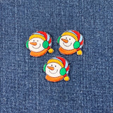 Three colorful snowman patches on a denim background