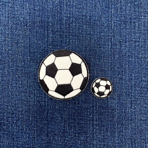 2 soccer ball patches on a denim background