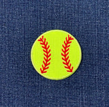 Yellow softball patch with red stitching on a blue denim background