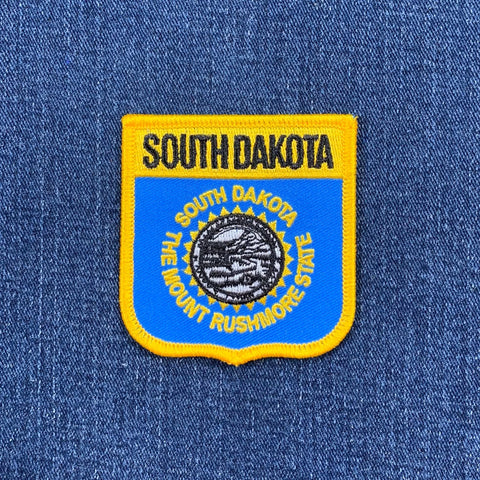 South Dakota state patch on a blue denim background