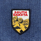 Patch with 'South Dakota' text and Mount Rushmore on a blue denim background