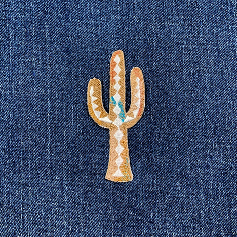 Embroidered cactus patch on denim fabric