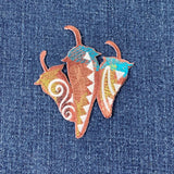 southwest peppers embroidered patch on a denim background