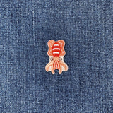 a mini squid patch on a denim background