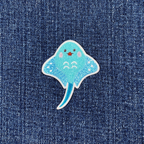 Blue stingray patch on denim fabric