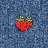 red and green strawberry patch on a denim background