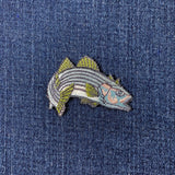 Fish-shaped patch on a denim background