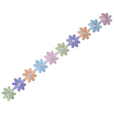 Long, narrow embroidered appliqué border strip consisting of ten small, interconnected daisy-like flowers in an alternating pattern of pastel colors, including light green, purple, orange, light blue, and pink. 