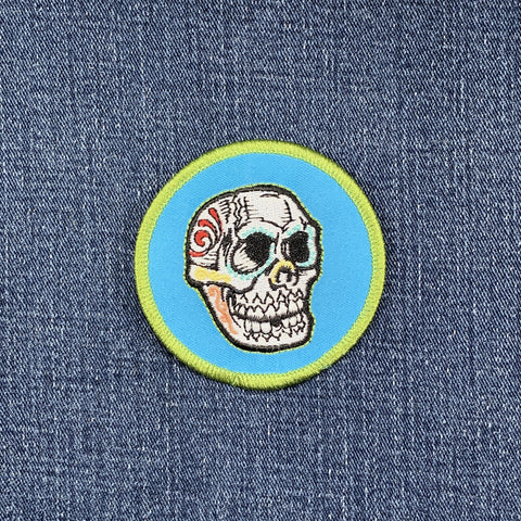 Skull patch with colorful design on a blue denim background