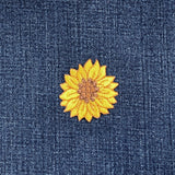 Yellow sunflower patch on blue denim fabric