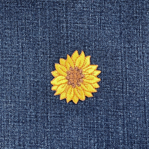 Yellow sunflower patch on blue denim fabric