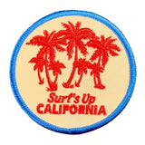Round patch with red palm trees and 'Surf's Up California' text on a white background