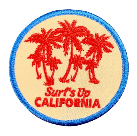 Round patch with red palm trees and 'Surf's Up California' text on a white background