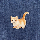Embroidered cat patch on denim fabric