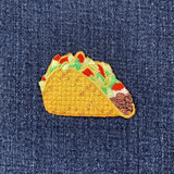 a taco patch on a denim background