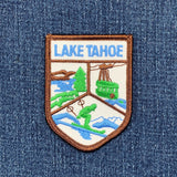 Embroidered patch of Lake Tahoe on a denim background