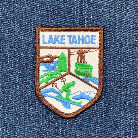 Embroidered patch of Lake Tahoe on a denim background