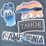 Set of Lake Tahoe-themed stickers on a denim background