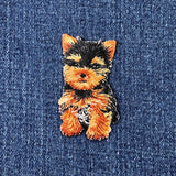 Embroidered patch of a Yorkie dog on denim fabric