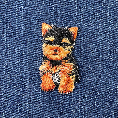 Embroidered patch of a Yorkie dog on denim fabric