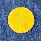 embroidered patch of a tennis ball on blue denim fabric