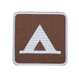 An embroidered square patch featuring a white tent icon on a brown background with a white border, isolated on a white background.