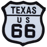 Embroidered patch in the shape of a shield with 'TEXAS US 66' text, primarily black and white with a solid background.