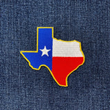 Texas state shaped flag patch on a denim background