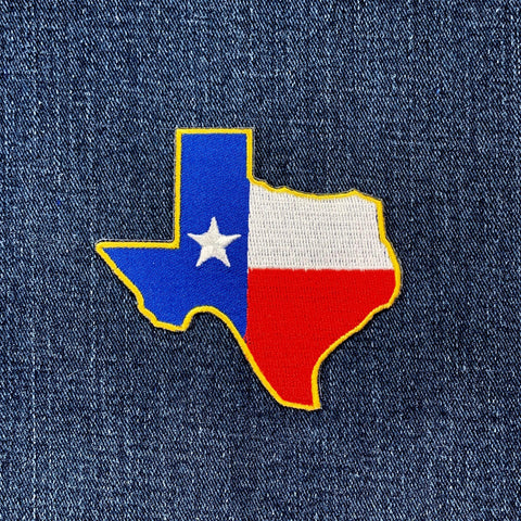 Texas state shaped flag patch on a denim background