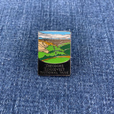Pin with Theodore Roosevelt National Park design on a denim background