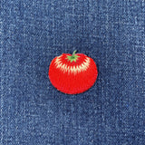 Red tomato patch on a blue denim background