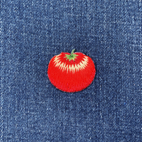 Red tomato patch on a blue denim background