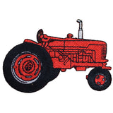 A red tractor applique patch with black wheels and details designed for iron-on application.