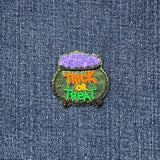 Embroidered patch with 'Trick or Treat' text on a denim background