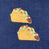 Two taco-shaped patches on a denim background